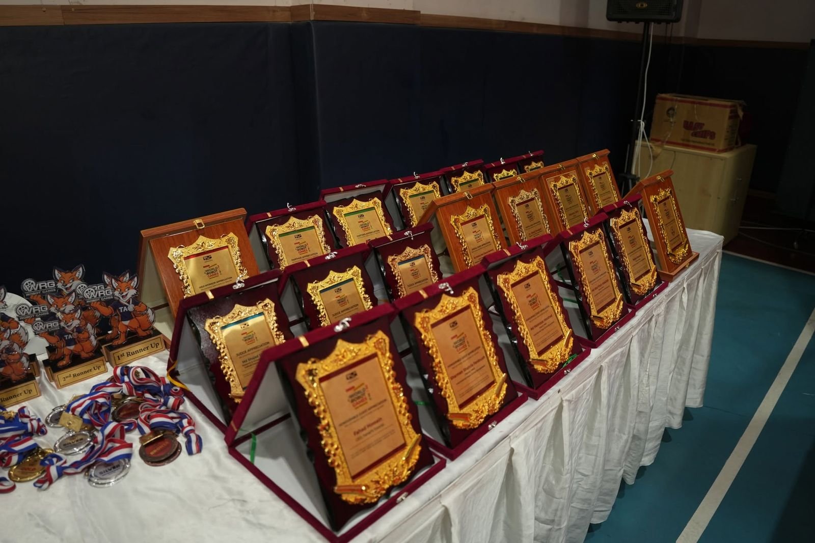 Rows of award plaques, trophies and medals laid out on a table ahead of the ceremony