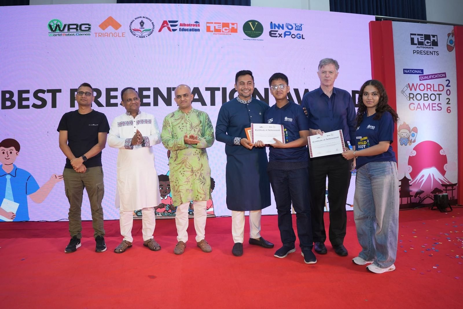 Best Presentation Award winners holding certificates on stage