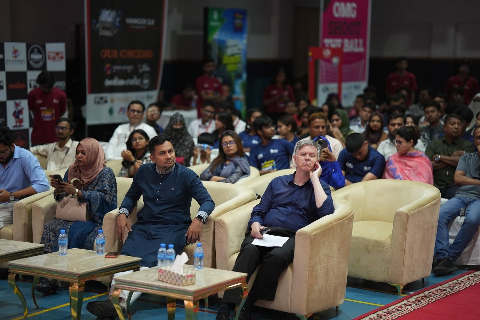 Guests and participants seated in the hall, following the programme