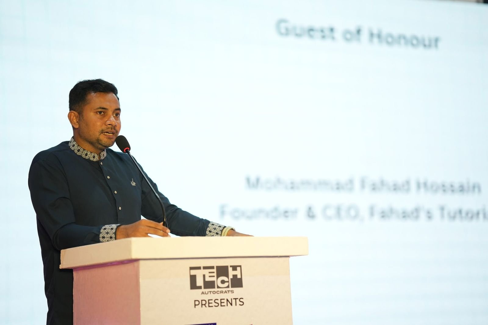 The guest of honour speaks from the Tech Autocrats podium